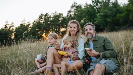 A family sitting on grass