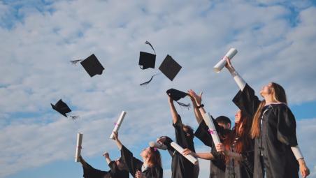 Graduates throwing their mortarboards