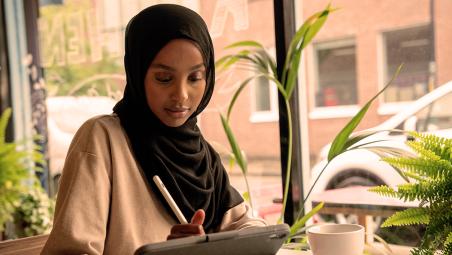 Lady in cafe looking at tablet