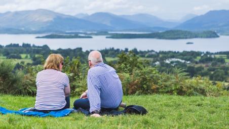 Man and lady sitting on grass