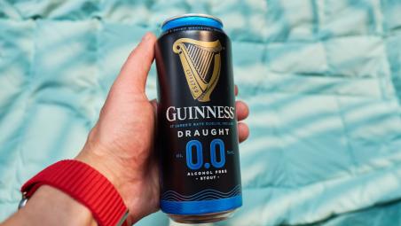 A man holding a can of Guinness Zero