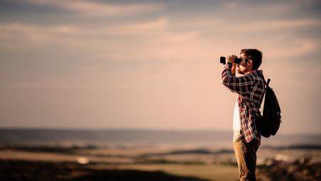Man looking through binoculars