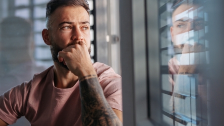 Man looking through window