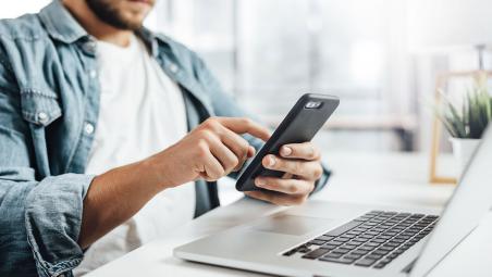 Man on phone at laptop