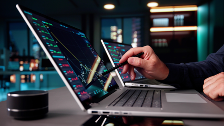 Man with digital pen on laptop