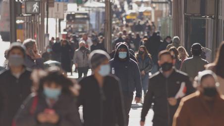 People wearing surgical masks in crowded street