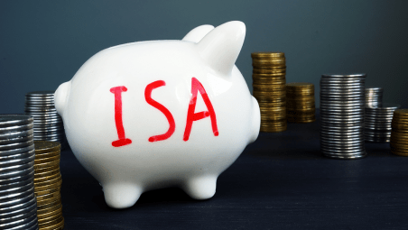 Piggy bank with ISA and stacked coins