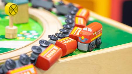 A toy train coming off the rails