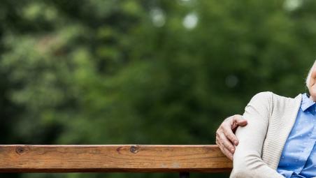 Elderly couple sat on a bench