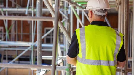builder on construction site wearing high vis