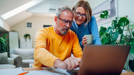 Couple investing on laptop