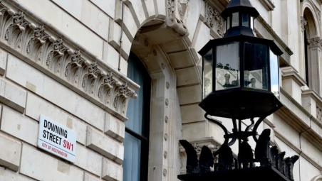 downing street sign on the wall of the government building in london