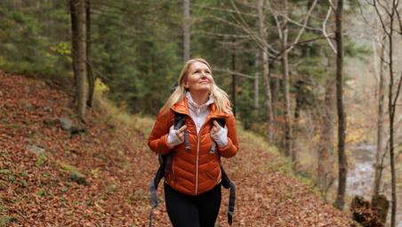 female hiker in the forest during autumn