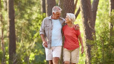 Retired couple walking in a forest