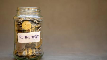 glass jar of coins with the label for retirement