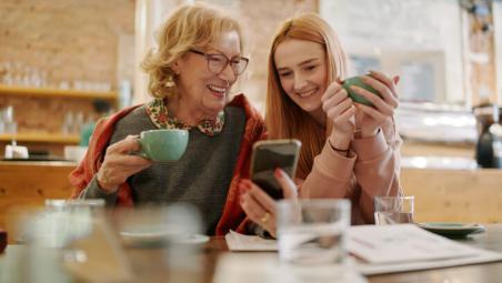grandmother smiling with granddaughter in a cafe
