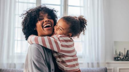 happy child hugging smiling mum