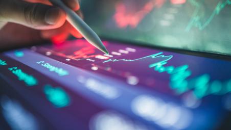 investor reviewing financial dashboard with graphs
