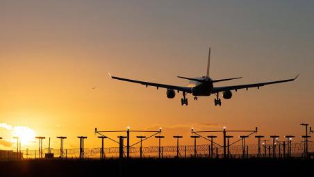 Plane landing during sunset