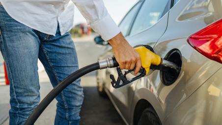 man refueling a car at petrol station