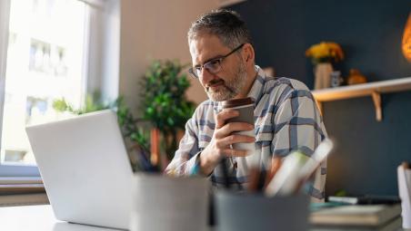 Man sitting looking at laptop 