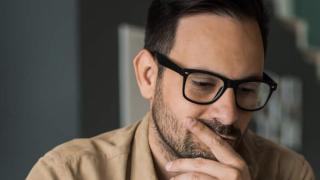 Man with laptop thinking