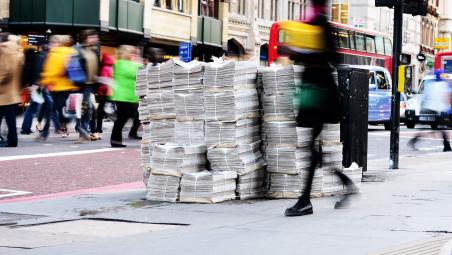 newspapers piled up on london street