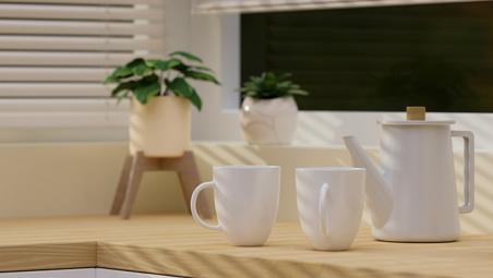two tea cups and a tea pot on a wooden counter top in a modern kitchen