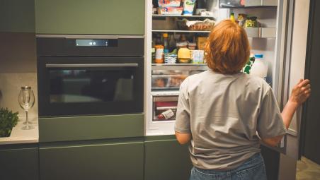 person choosing food from the fridge