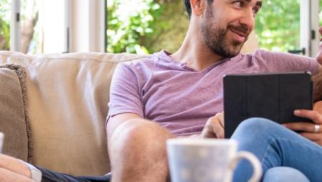 Couple discussing finances on sofa