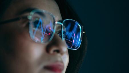 reflection of a graph in a woman's glasses