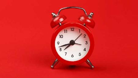 Red clock on a red background