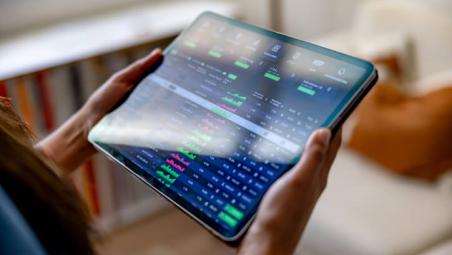 tablet screen with investment graphs