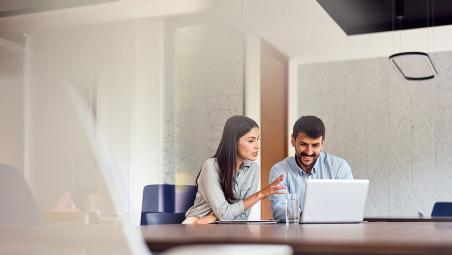 two business people using laptop