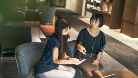 two women discussing in a modern office