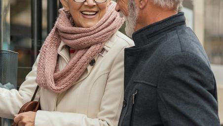 Retired couple taking out money at an ATM