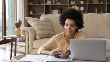 woman doing her finances in the living room at home