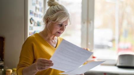 woman going through paperwork in the kitchen