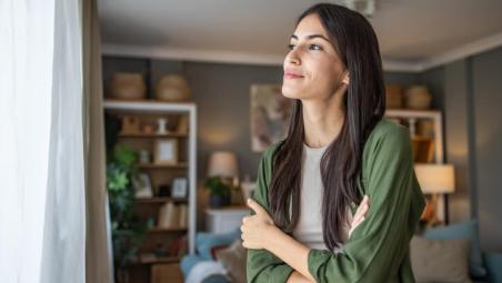 woman looking out the window at home