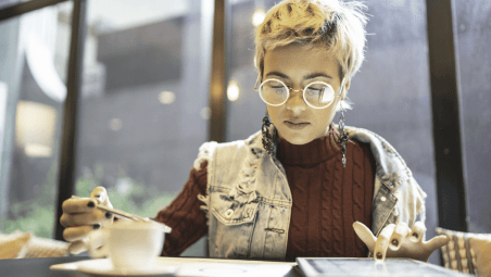 Woman studying notes and a tablet