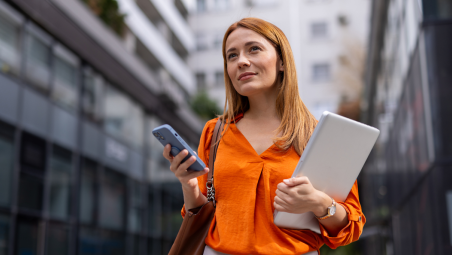 Redhead woman on street with mobile phone