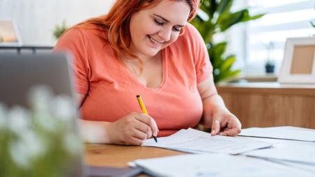 young woman filling in paper applications