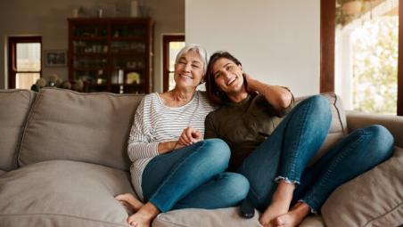young woman sitting on sofa with mum